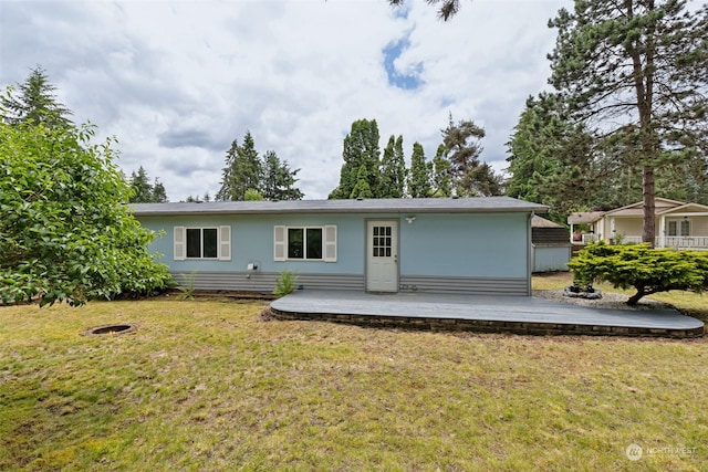 back of house with a lawn