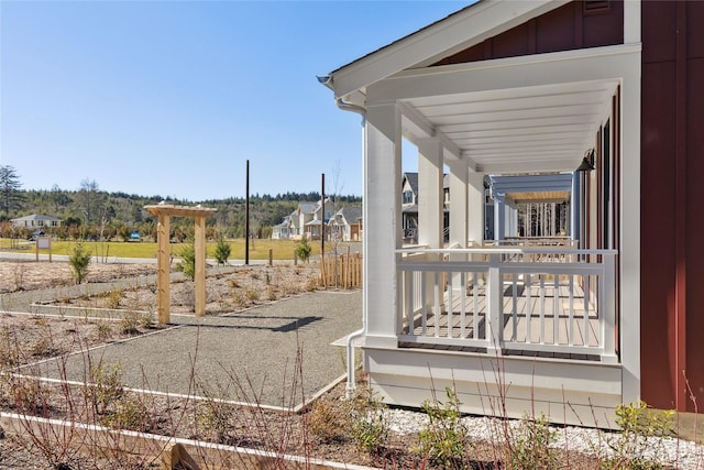 view of yard featuring covered porch