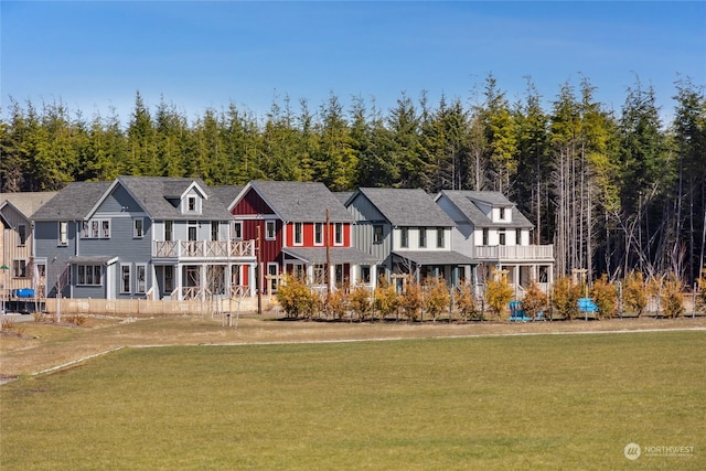 view of front of home with a front yard and a balcony