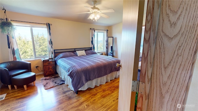 bedroom featuring hardwood / wood-style flooring and ceiling fan