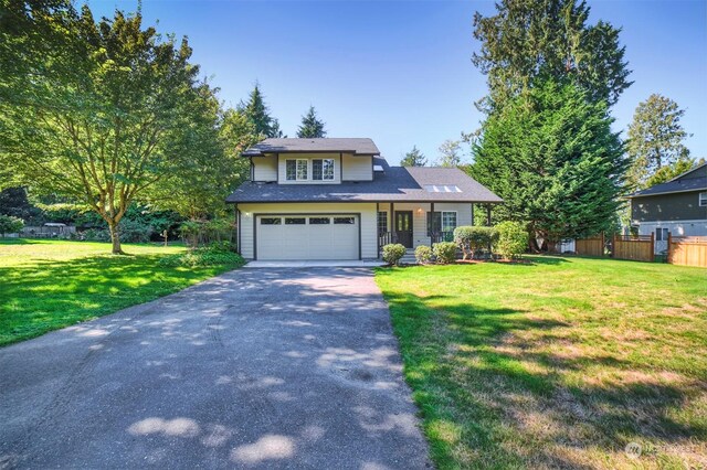 view of front of home featuring a front lawn and a garage