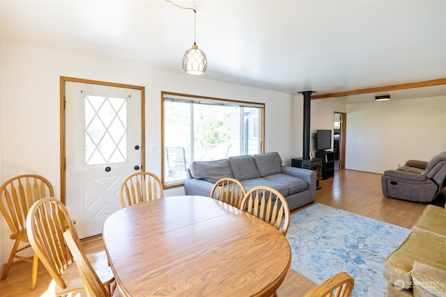 dining room featuring a wood stove and hardwood / wood-style flooring