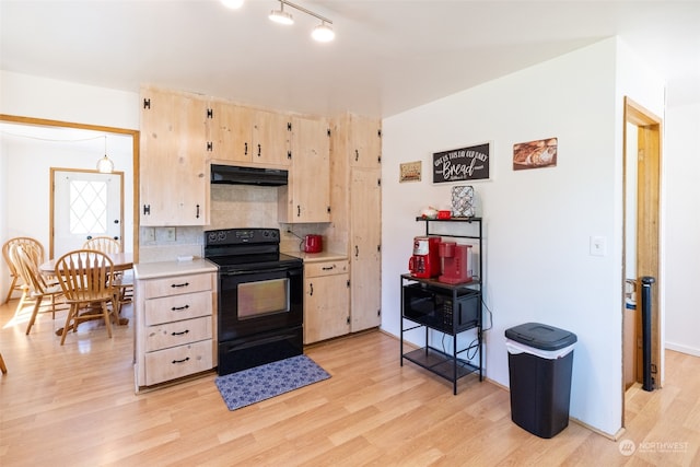 kitchen with light brown cabinetry, light hardwood / wood-style flooring, electric range, and backsplash