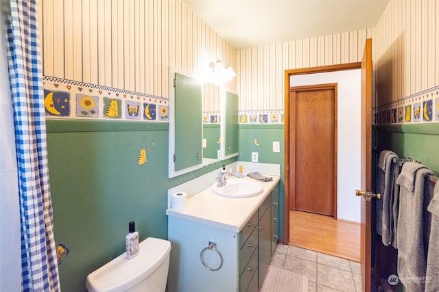 bathroom featuring vanity, hardwood / wood-style flooring, and toilet