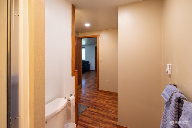 bathroom with wood-type flooring and toilet