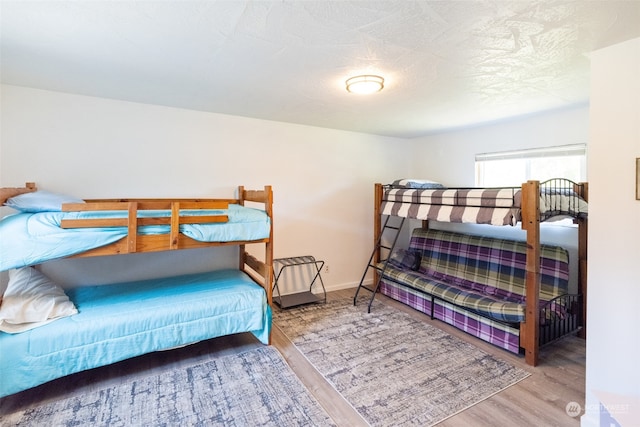 bedroom with hardwood / wood-style flooring