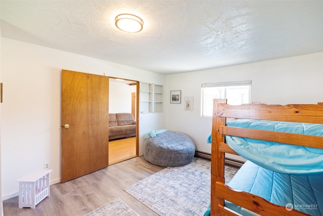 bedroom with hardwood / wood-style floors