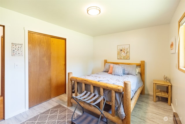 bedroom featuring hardwood / wood-style flooring and a closet