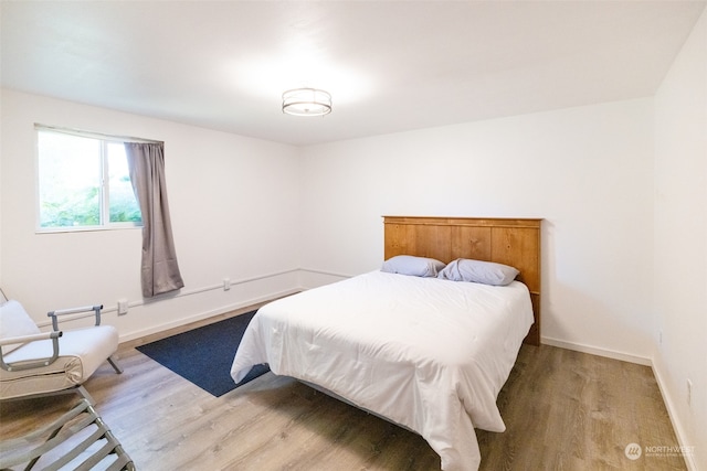 bedroom with hardwood / wood-style flooring