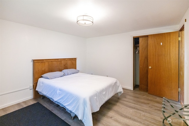 bedroom with hardwood / wood-style flooring and a closet