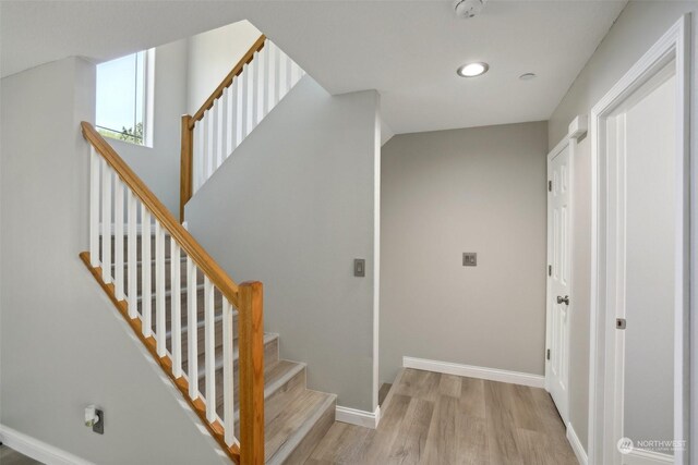 staircase with light hardwood / wood-style flooring