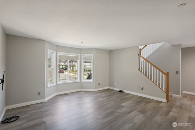 interior space featuring a textured ceiling and hardwood / wood-style floors