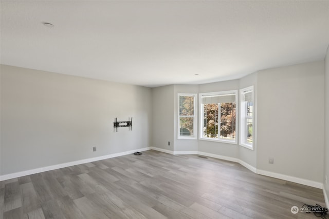 spare room with hardwood / wood-style floors