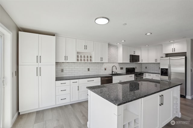 kitchen featuring white cabinetry, light wood-type flooring, and stainless steel appliances