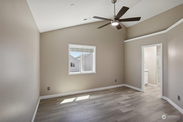 empty room with wood-type flooring, ceiling fan, and vaulted ceiling