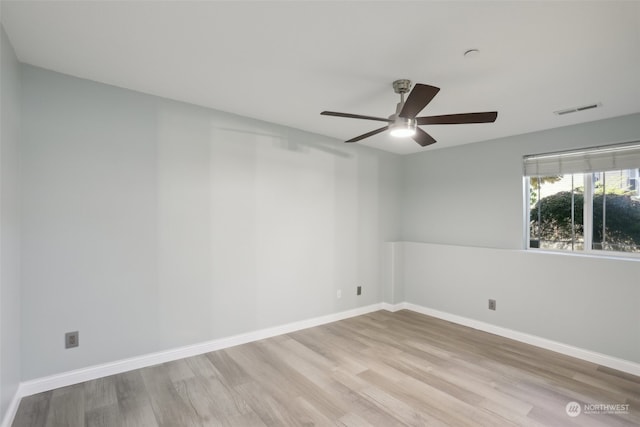 spare room featuring wood-type flooring and ceiling fan