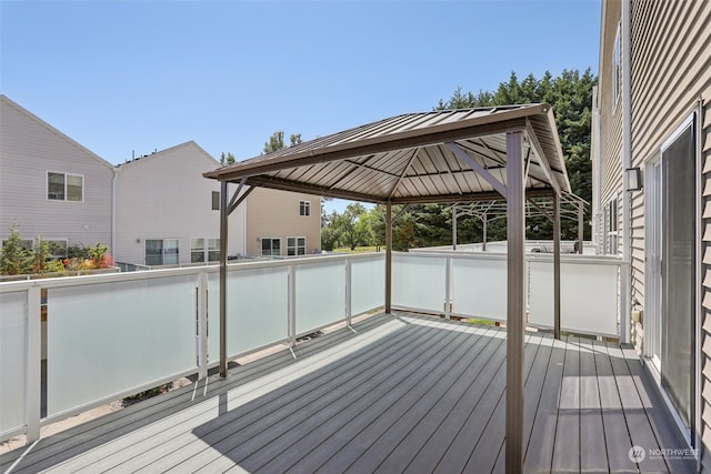 wooden terrace featuring a gazebo