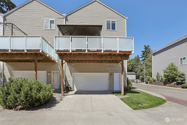 view of front of home featuring a balcony and a garage