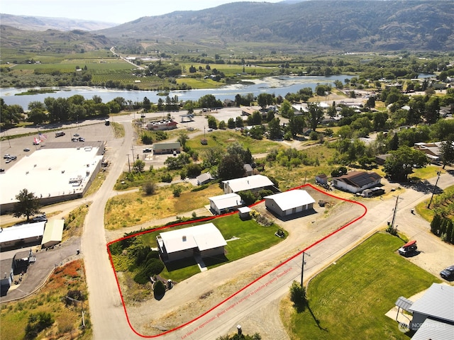 aerial view featuring a water and mountain view