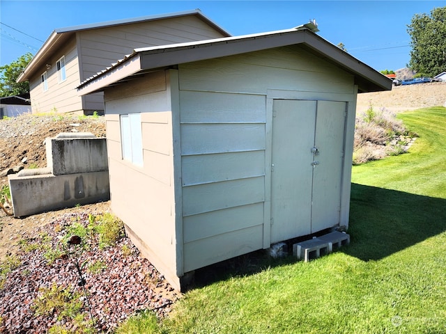 view of outbuilding with a lawn