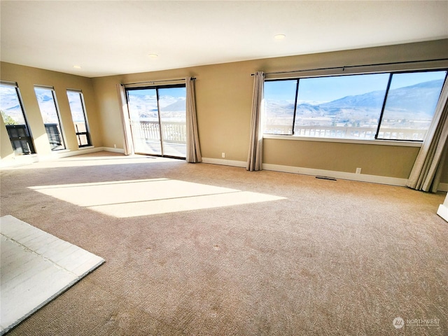 carpeted empty room with a mountain view