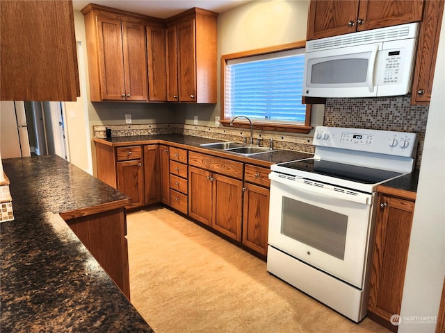 kitchen with sink, backsplash, and white appliances