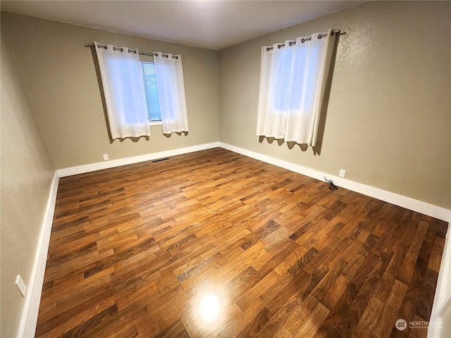 unfurnished room featuring hardwood / wood-style flooring