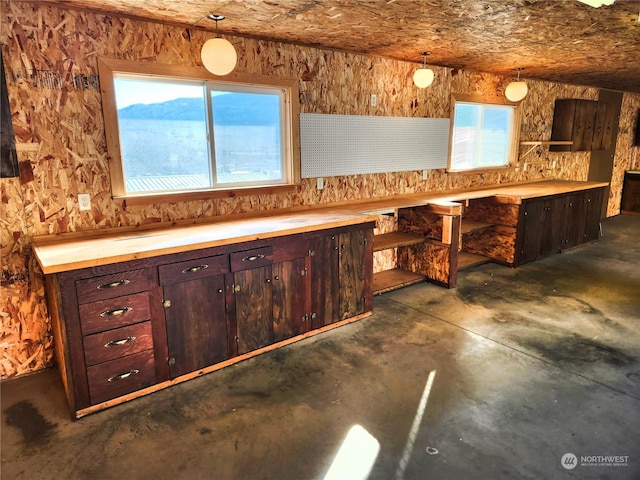 kitchen featuring hanging light fixtures, a mountain view, and dark brown cabinets