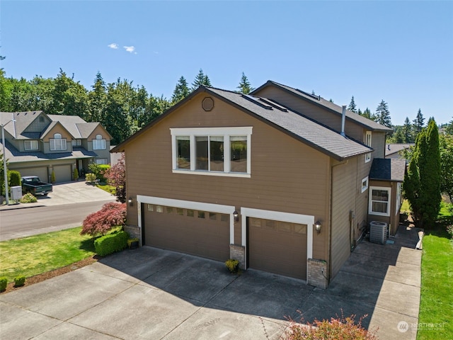 view of front of house featuring central AC and a garage