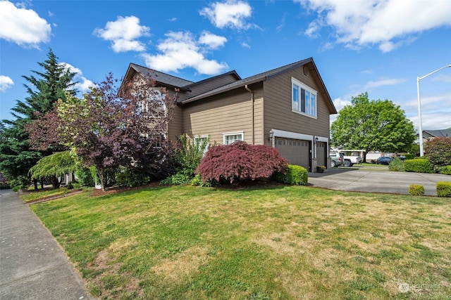 view of side of home featuring a garage and a yard