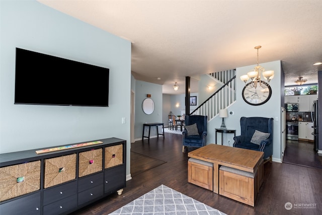 living room with dark hardwood / wood-style floors and a notable chandelier