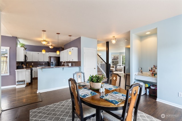 dining space with dark wood-type flooring