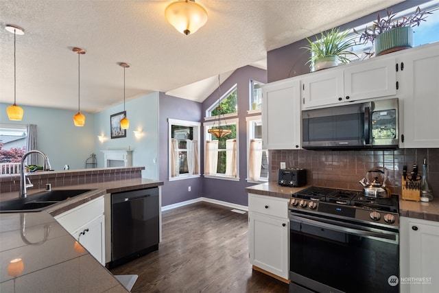 kitchen with white cabinets, decorative light fixtures, stainless steel appliances, and sink