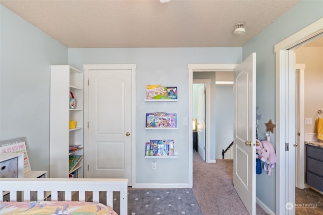 bedroom featuring a textured ceiling and carpet floors