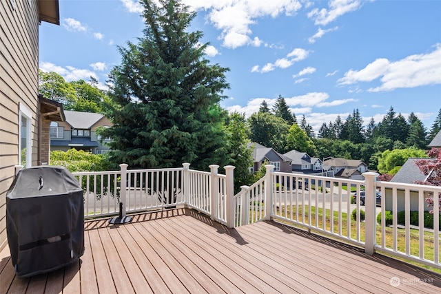 wooden terrace with a grill