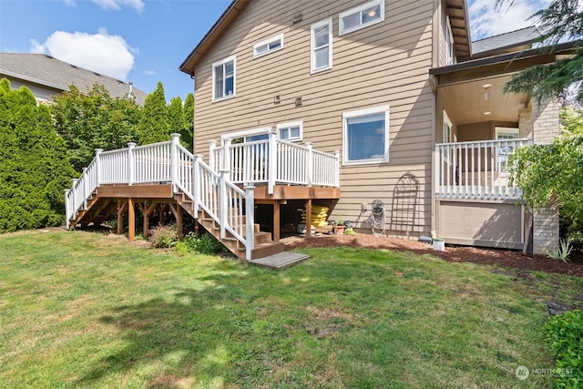 rear view of property with a deck and a lawn