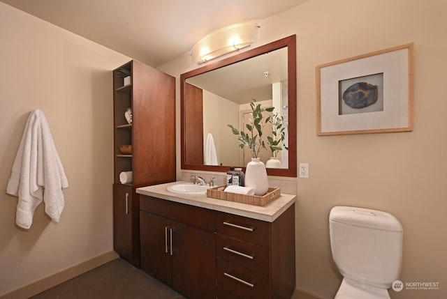 bathroom featuring tile patterned floors, vanity, and toilet