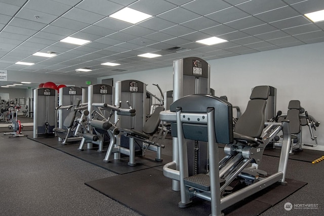 exercise room with a paneled ceiling