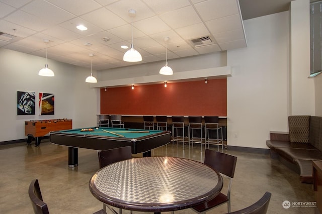 game room with a drop ceiling, concrete floors, and pool table