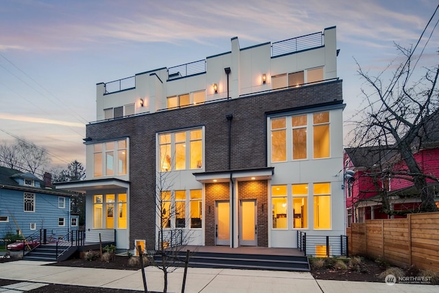 view of back house at dusk