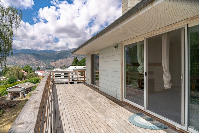 wooden deck with a mountain view