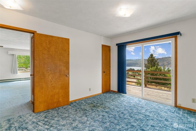 spare room featuring a baseboard radiator and carpet floors