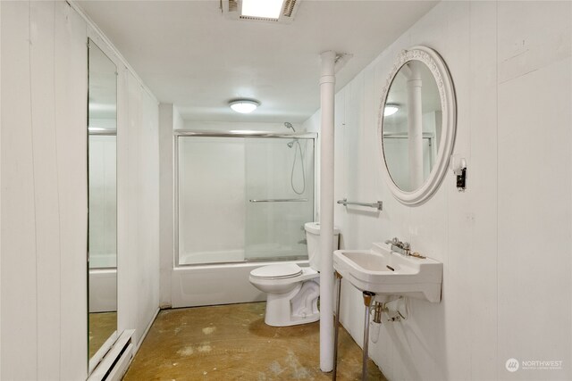 bathroom with enclosed tub / shower combo, a baseboard radiator, toilet, and concrete flooring