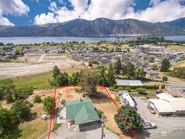 drone / aerial view featuring a water and mountain view