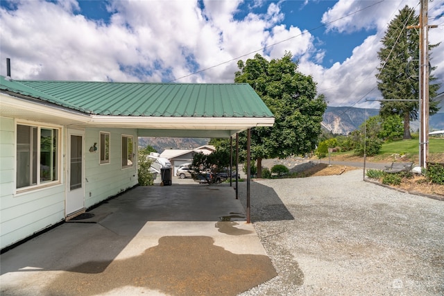 view of patio / terrace with a mountain view and a carport