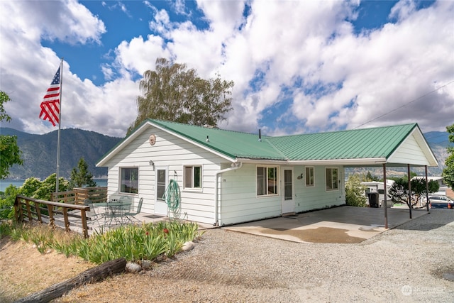 view of front of home with a carport and a mountain view