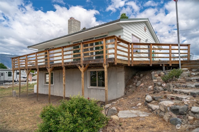 back of house with a wooden deck