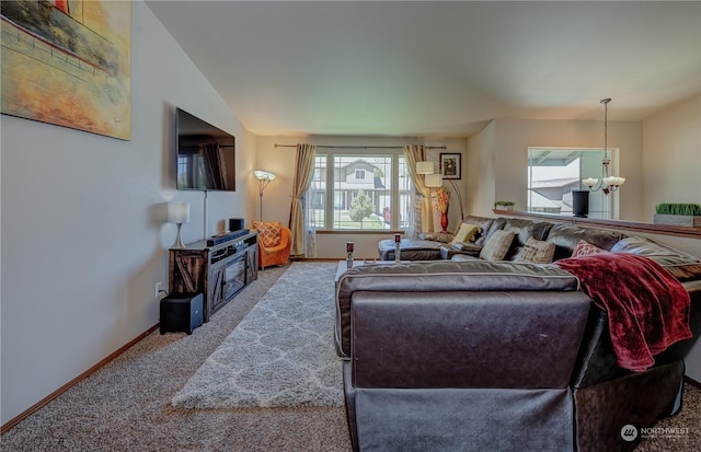 carpeted living room featuring a notable chandelier