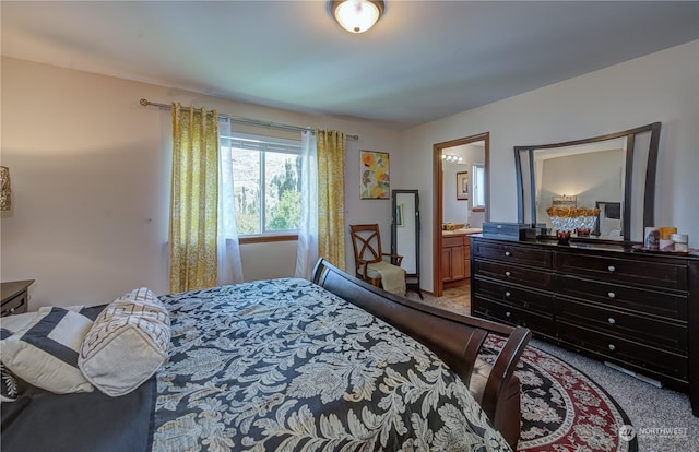 bedroom featuring carpet flooring and ensuite bathroom