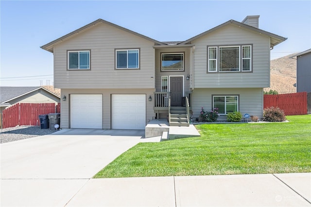 bi-level home featuring a front yard and a garage